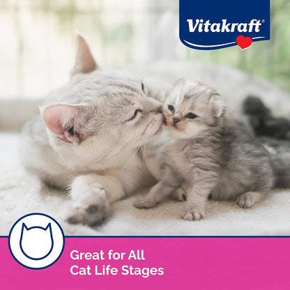 Owner feeding cat Vitakraft Lick N Lap by hand for bonding