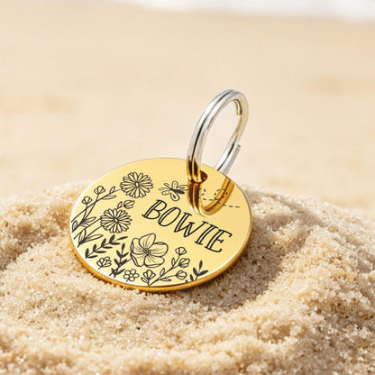 Customizable stainless steel dog tags with mountain and floral patterns.