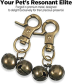 Two pieces of vintage copper dog collar bells with iron split rings displayed on a clean background.