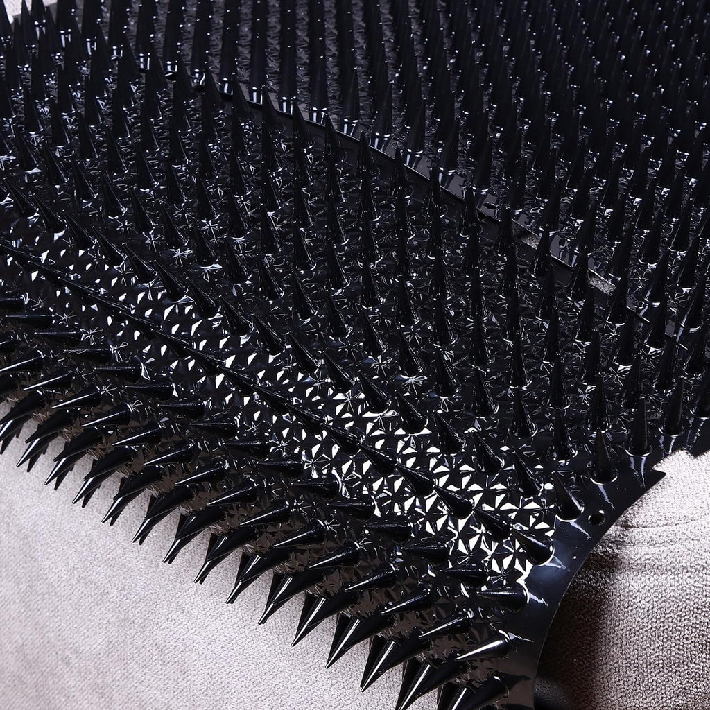 Plastic spike mat protecting potted plant