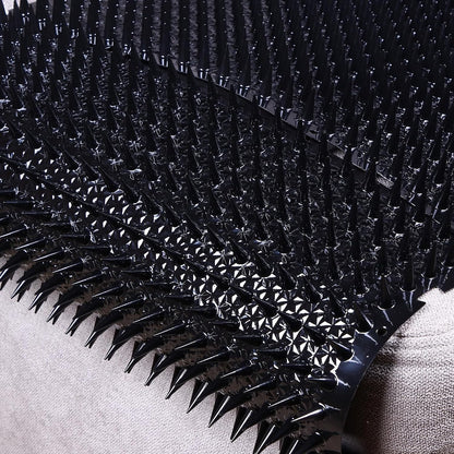Plastic spike mat protecting potted plant