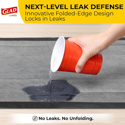 Glad black charcoal pet pee mats unboxed and spread on indoor floor