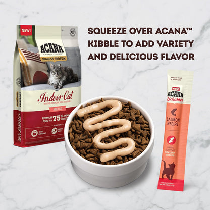 Cat enjoying ACANA Lickables salmon treat from a spoon