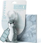 GRRREEN plush fish puzzle toy resting inside a modern pet basket to demonstrate its compact size.
