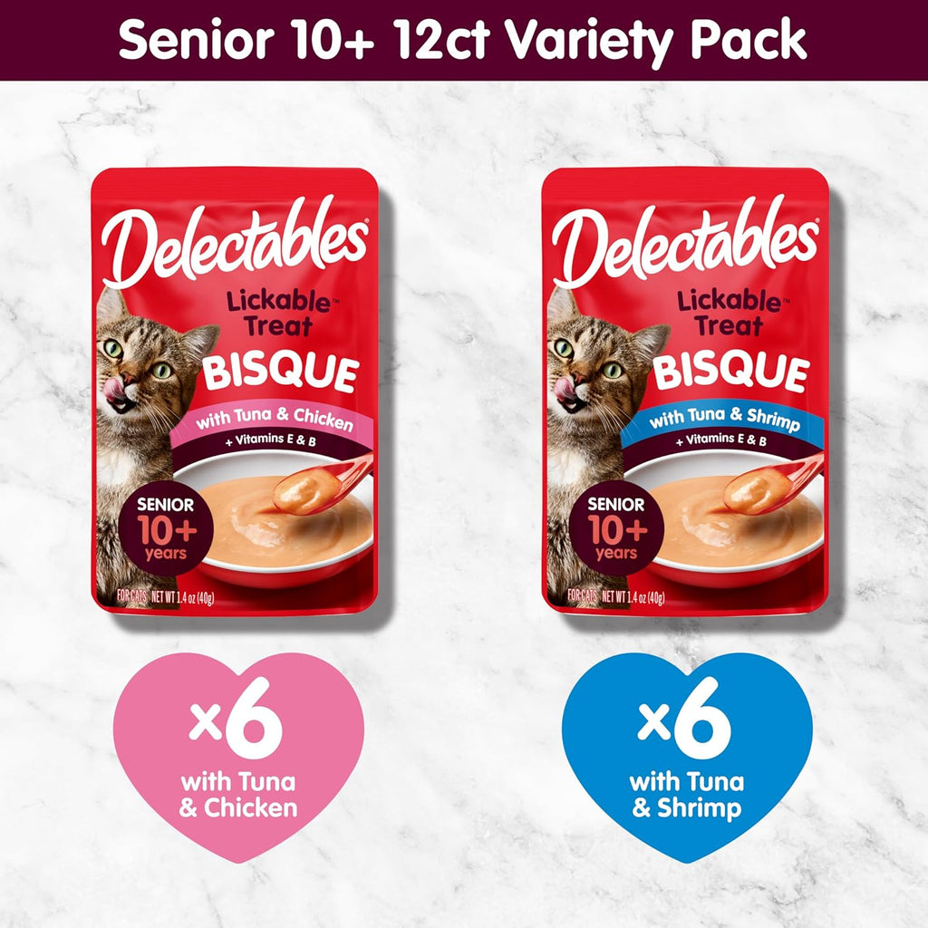 An aging cat enjoying the smooth texture of Delectables bisque lickable wet cat treats from a bowl.