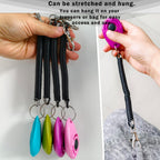 Multicolor teardrop dog clickers with black elastic wrist straps.