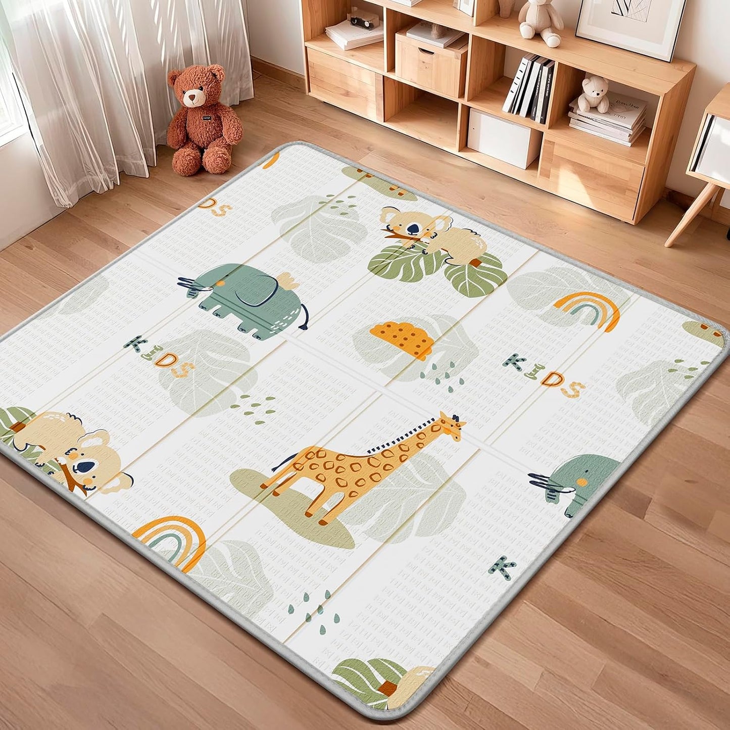 Piglog foldable baby play mat front view featuring giraffe and elephant design