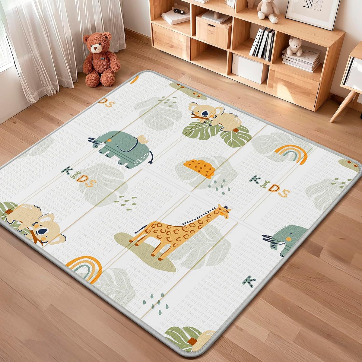 Piglog foldable baby play mat front view showing giraffe and elephant pattern