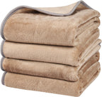 Khaki dog blanket spread across an indoor bed surface.