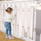 Minne Baby banister guard front view on white staircase railing.
