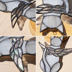 Angel cat stained glass hanging in a bright window