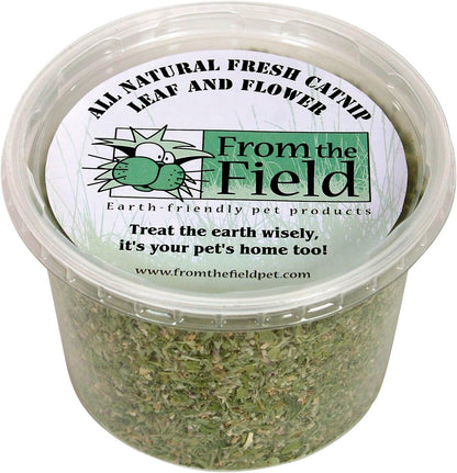 Crushed aromatic catnip leaves being sprinkled onto a cardboard cat scratching post