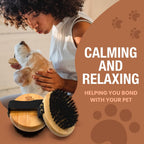 Soft boar bristle palm brush being used gently around a pet's face and ears for anxiety free shedding control.