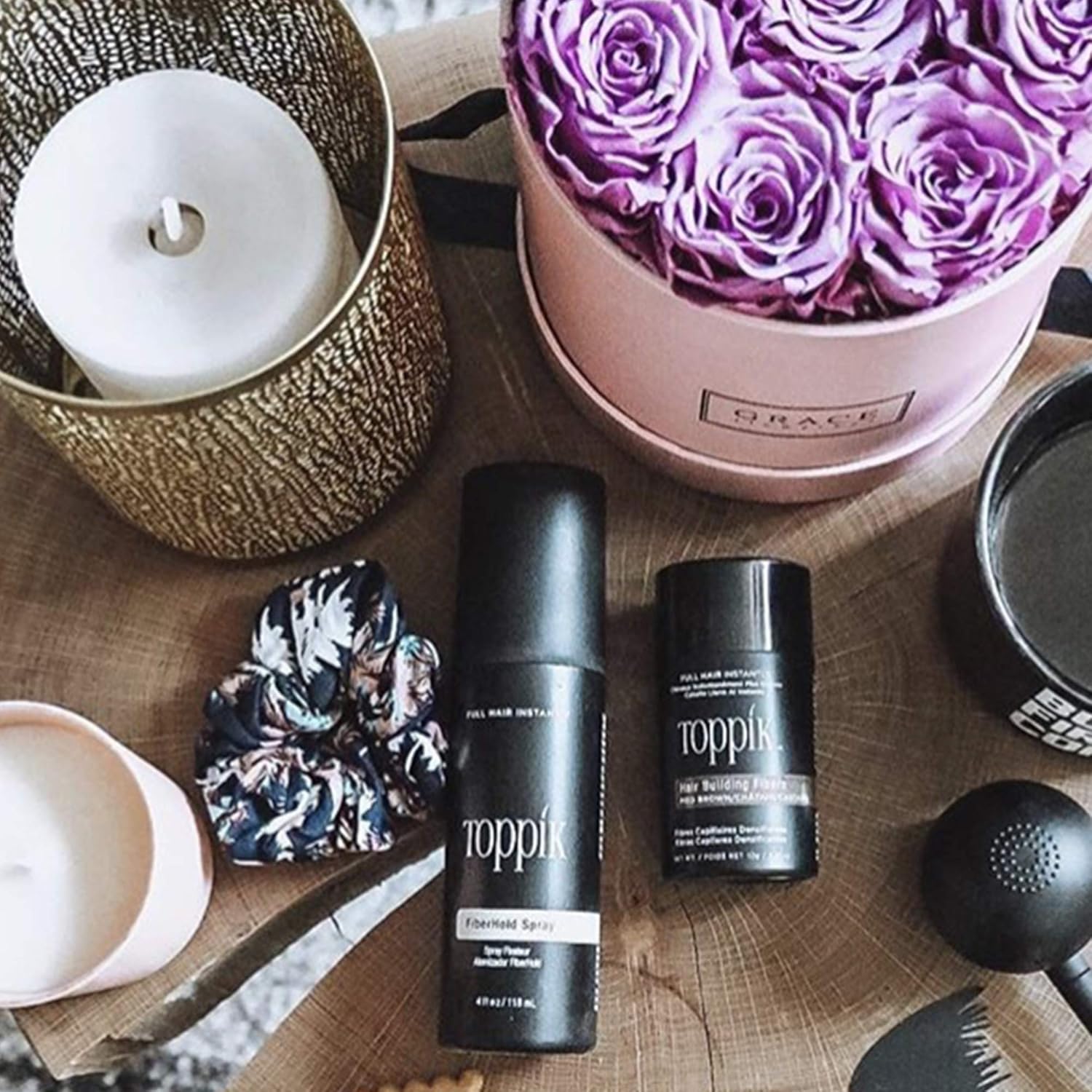 Toppik professional hair fiber setting spray bottle placed upright against a clean backdrop.