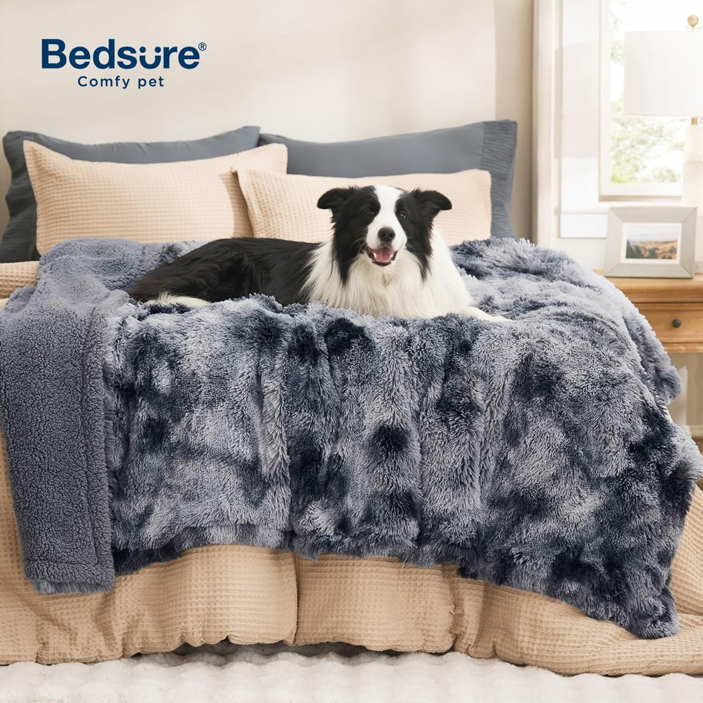 Bedsure faux fur calming pet blanket protecting living room fabric couch.