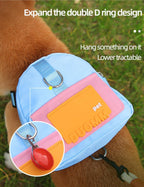 Vibrant blue and pink dog saddlebag harness packed with pet treats for outdoor hiking.