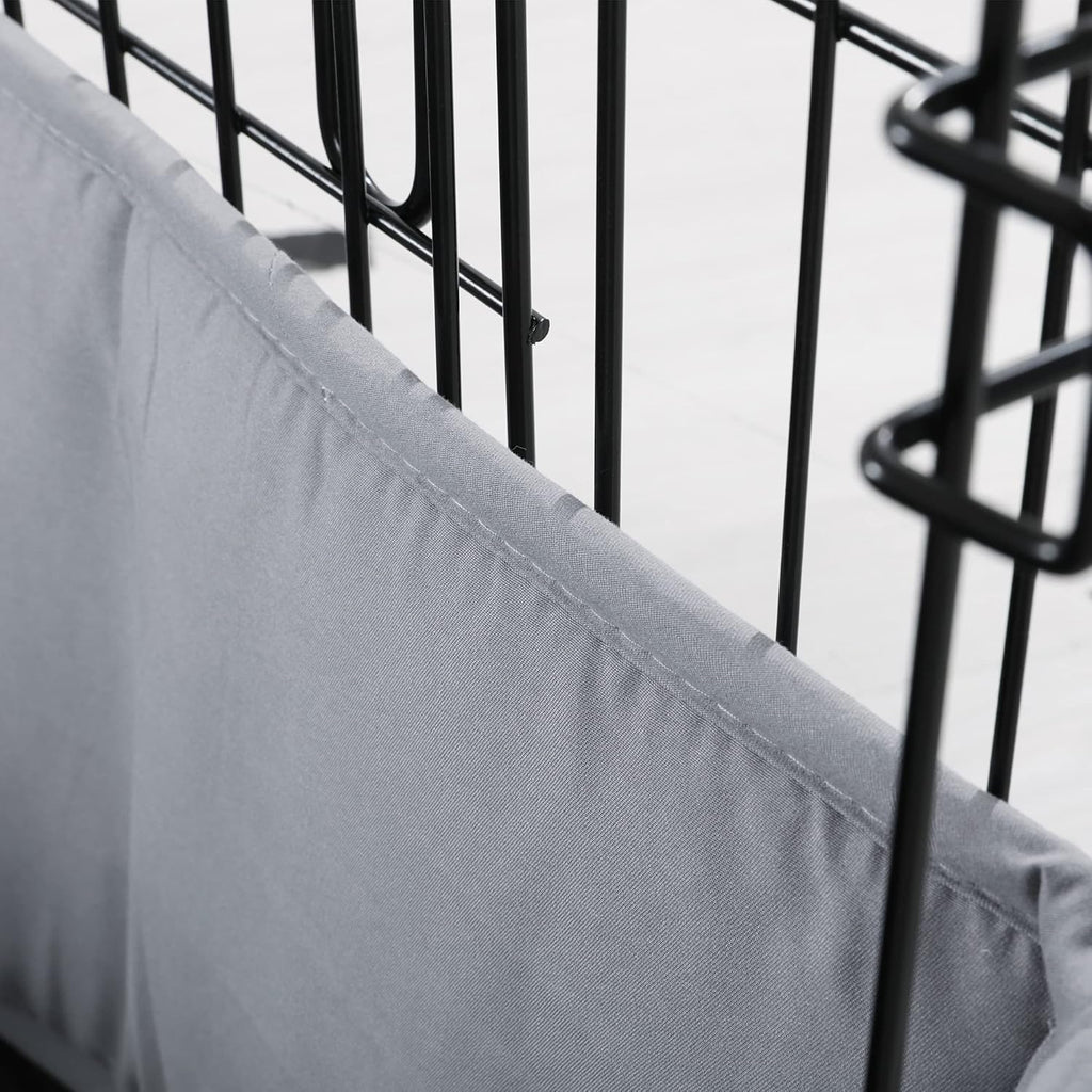 Small dog resting comfortably next to the half height gray kennel bumper guard