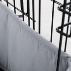 Small dog resting comfortably next to the half height gray kennel bumper guard
