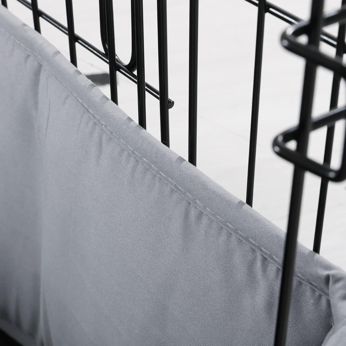 Small dog resting comfortably next to the half height gray kennel bumper guard