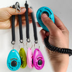 Purple and Pink animal behavior training clickers close up view.
