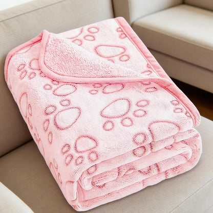 Cozy flannel fleece kitten blanket placed neatly on a living room sofa.