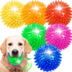 Bouncy squeaky light up spiky dog ball being squeezed for sound