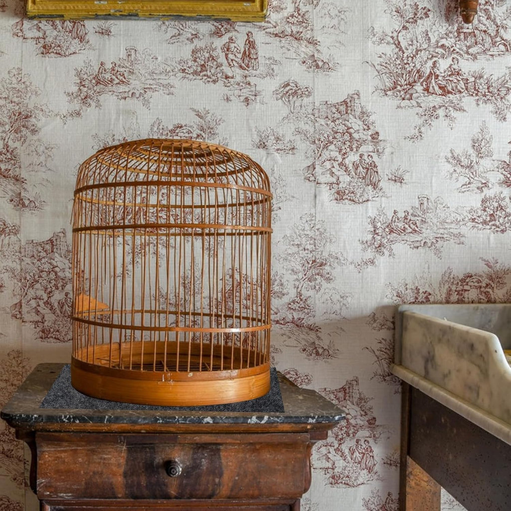 LYMOI bird cage mat placed beneath a large pet enclosure on a hardwood floor.