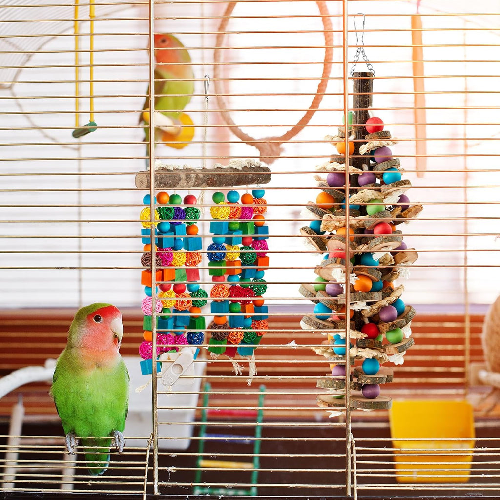 Hanging metal hook attachment mechanism secured to the top of the parrot chew toy