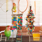 Hanging metal hook attachment mechanism secured to the top of the parrot chew toy