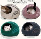 Cat relaxing on top of flattened Meowfia cat bed