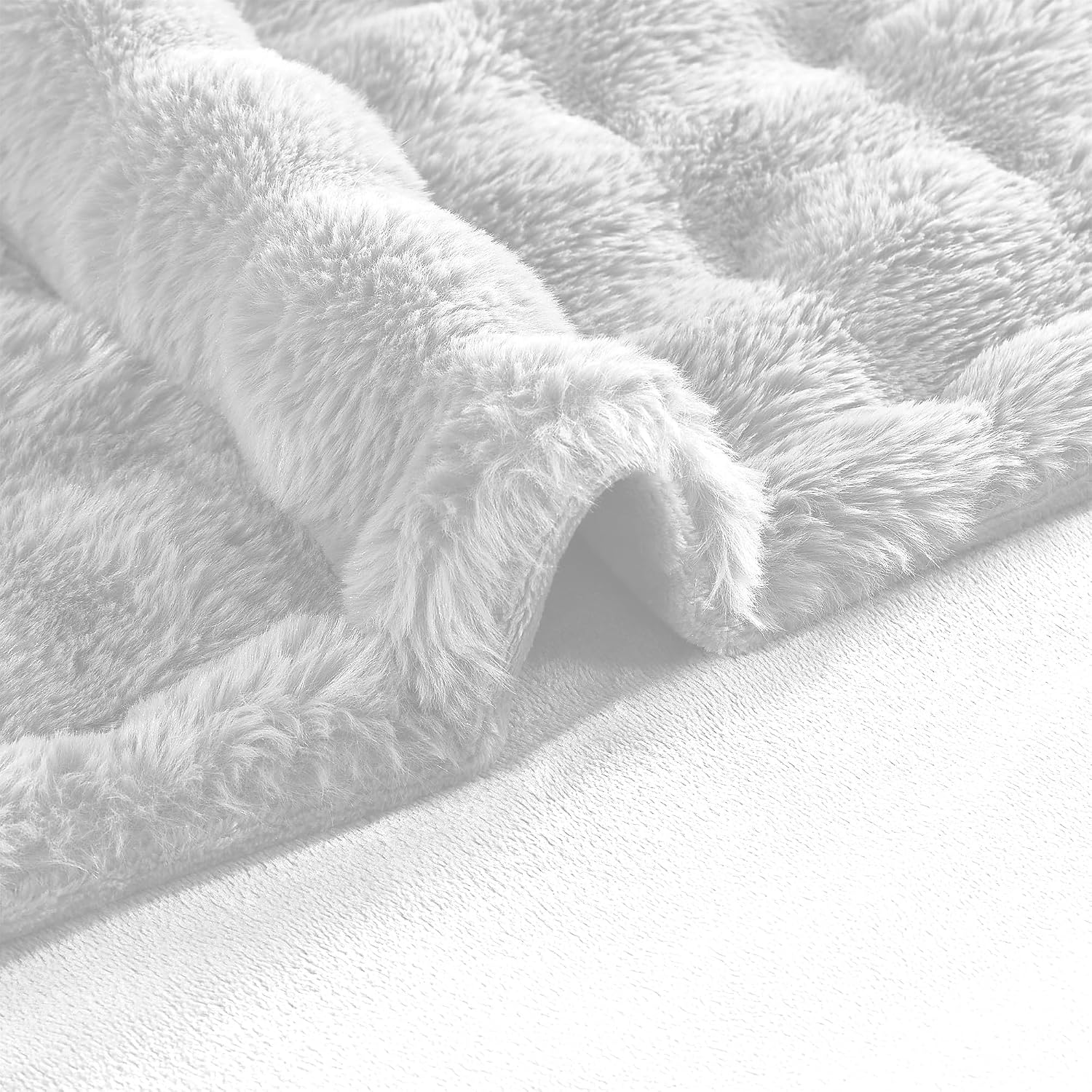 Fluffy cat resting on the plush white faux rabbit fur pet throw blanket.