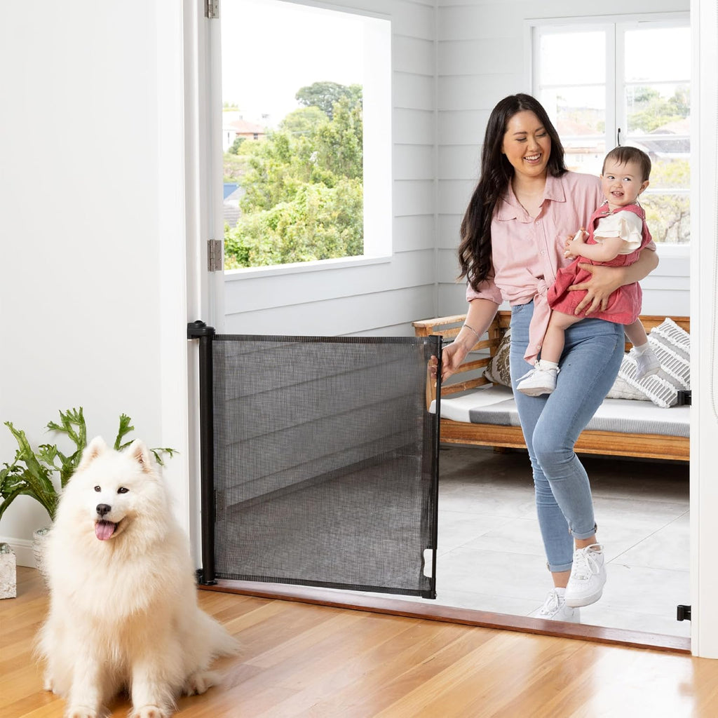 Perma Child Safety Retractable Baby Gate front view installed in an open doorway.