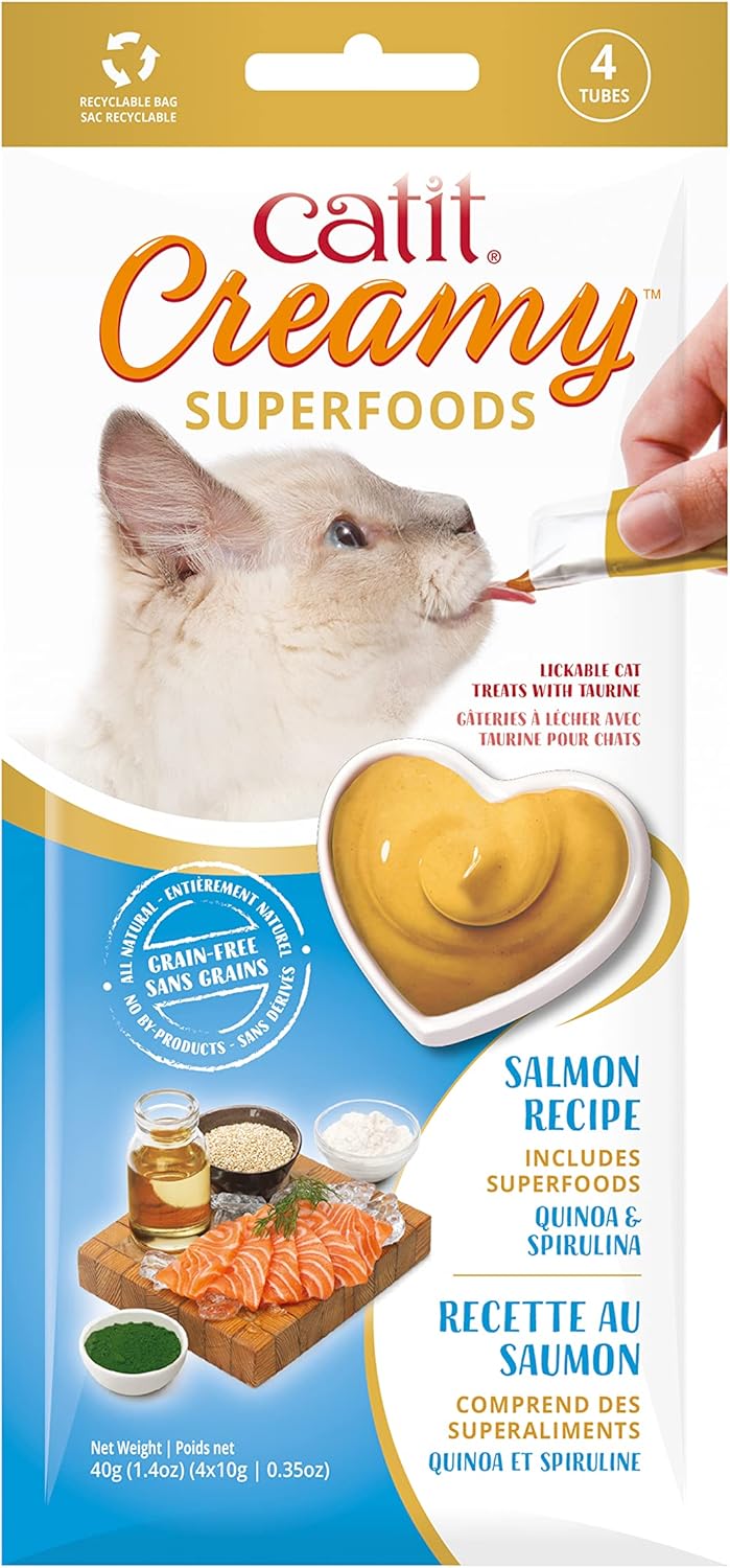 Cat owner hand feeding a cat using Catit Creamy Superfood tube