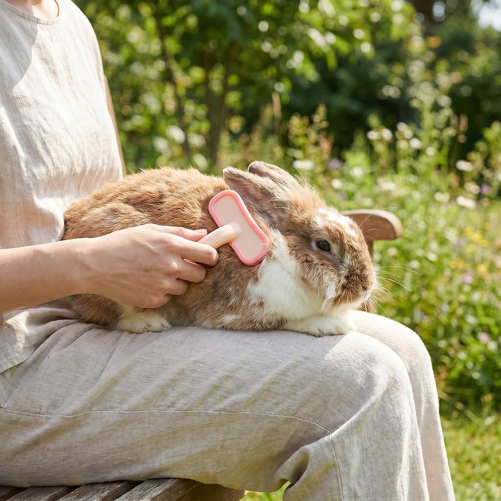 Pink silicone rabbit brush highlighting the compact size and flexible structure