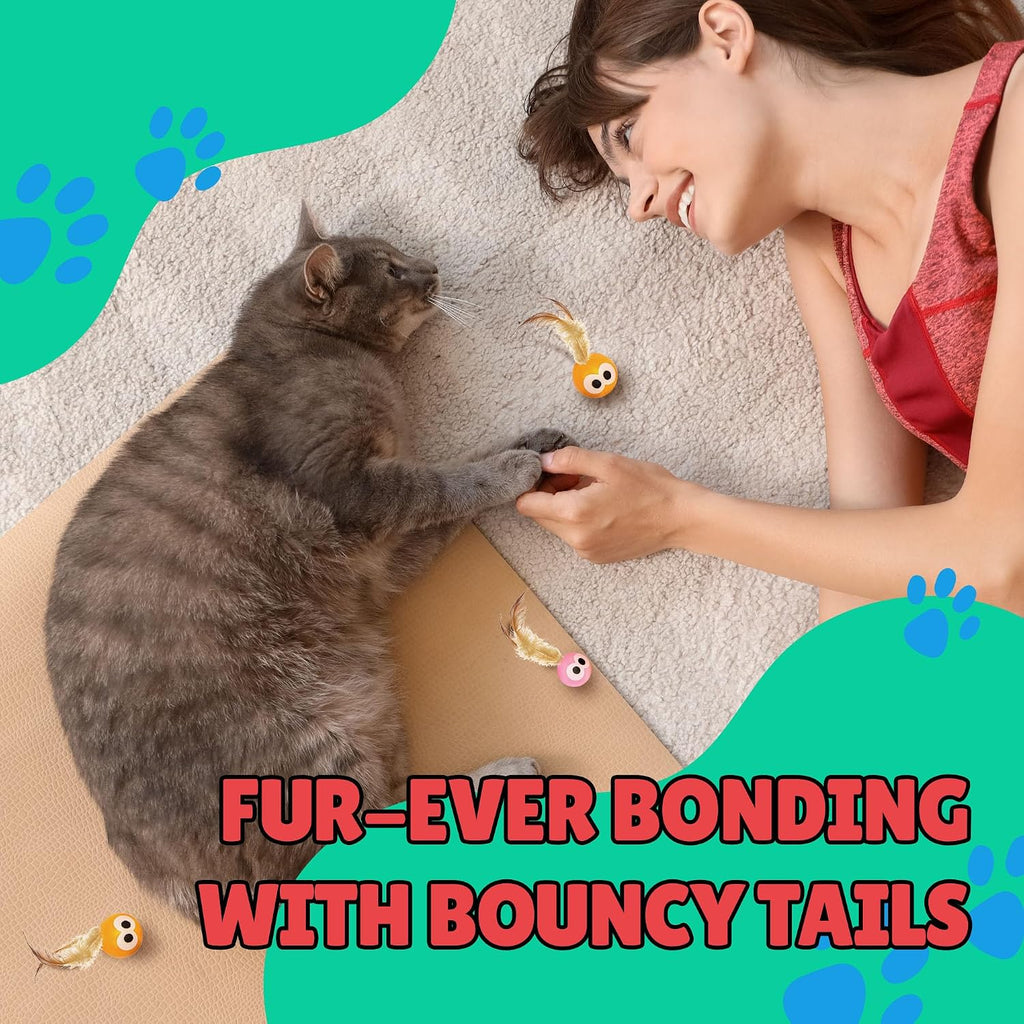 Playful kitten chasing Bouncy Tails natural feather ball toy.