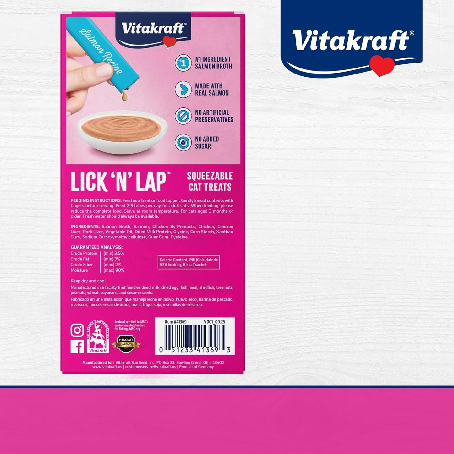 Vitakraft liquid cat treat squeeze tube being poured over dry food