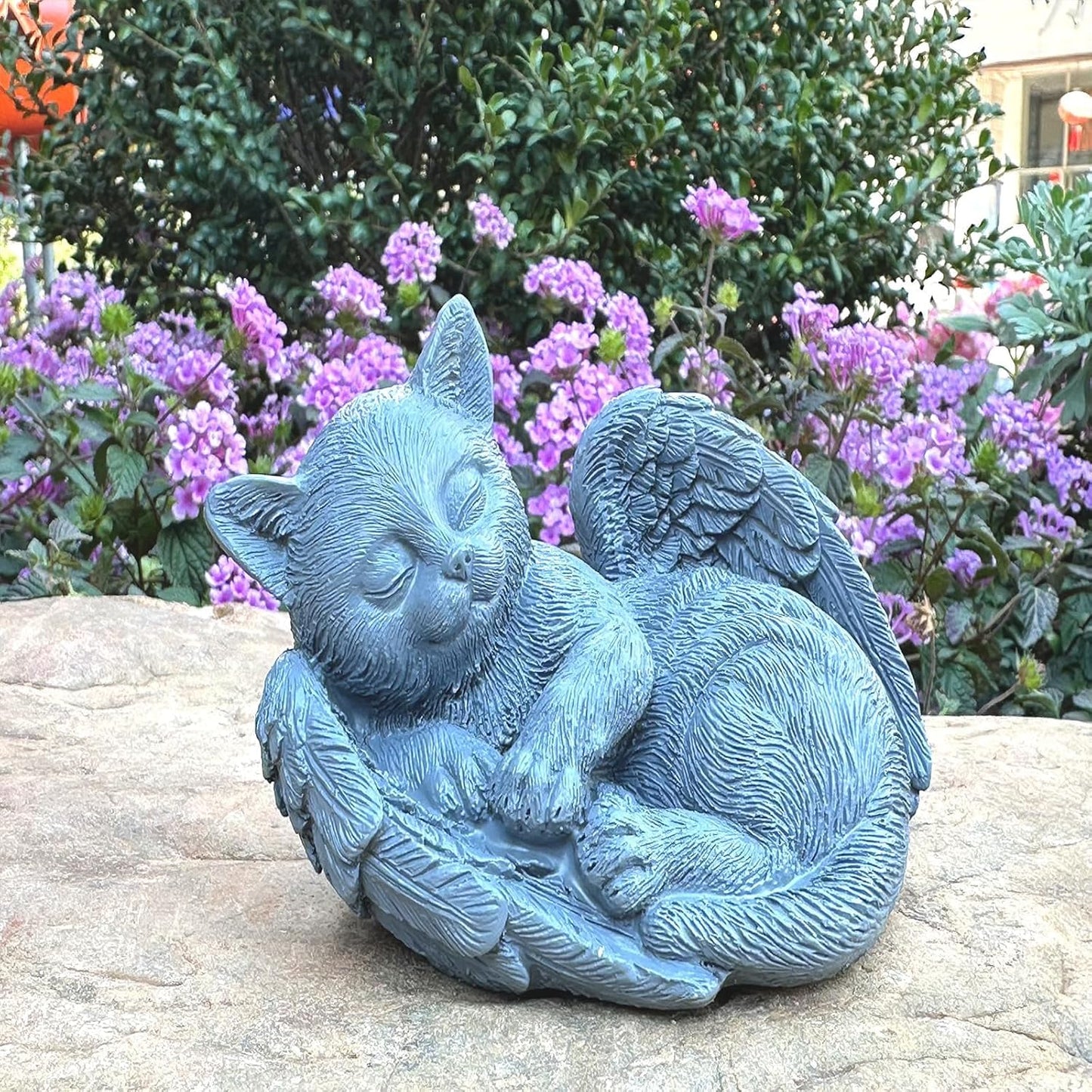 Weatherproof cat remembrance sculpture displayed outdoors in a green lawn setting