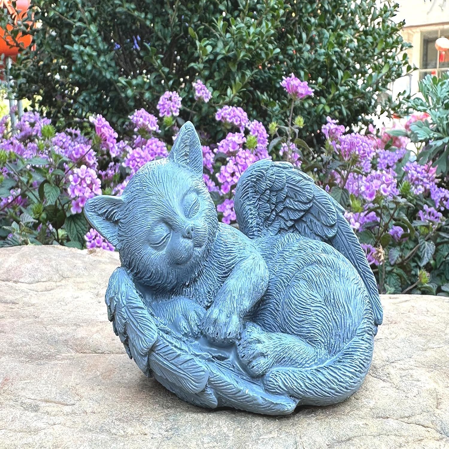 Weatherproof cat remembrance sculpture displayed outdoors in a green lawn setting