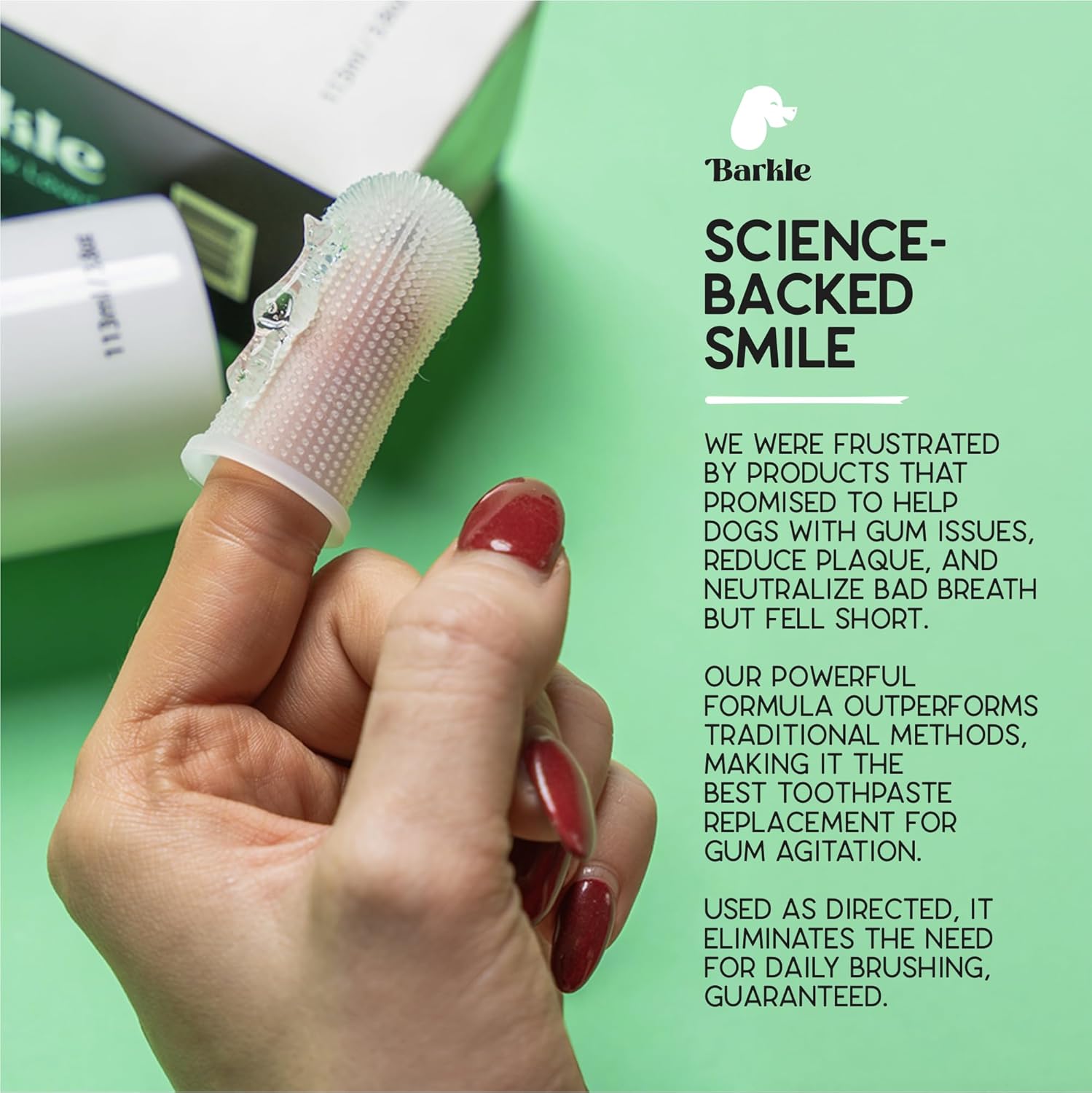 Pet owner applying Barkle gel to dog teeth with finger brush