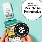 Applying Poo-Pourri Pawsitively Fresh spray on a fabric couch surface to remove stains