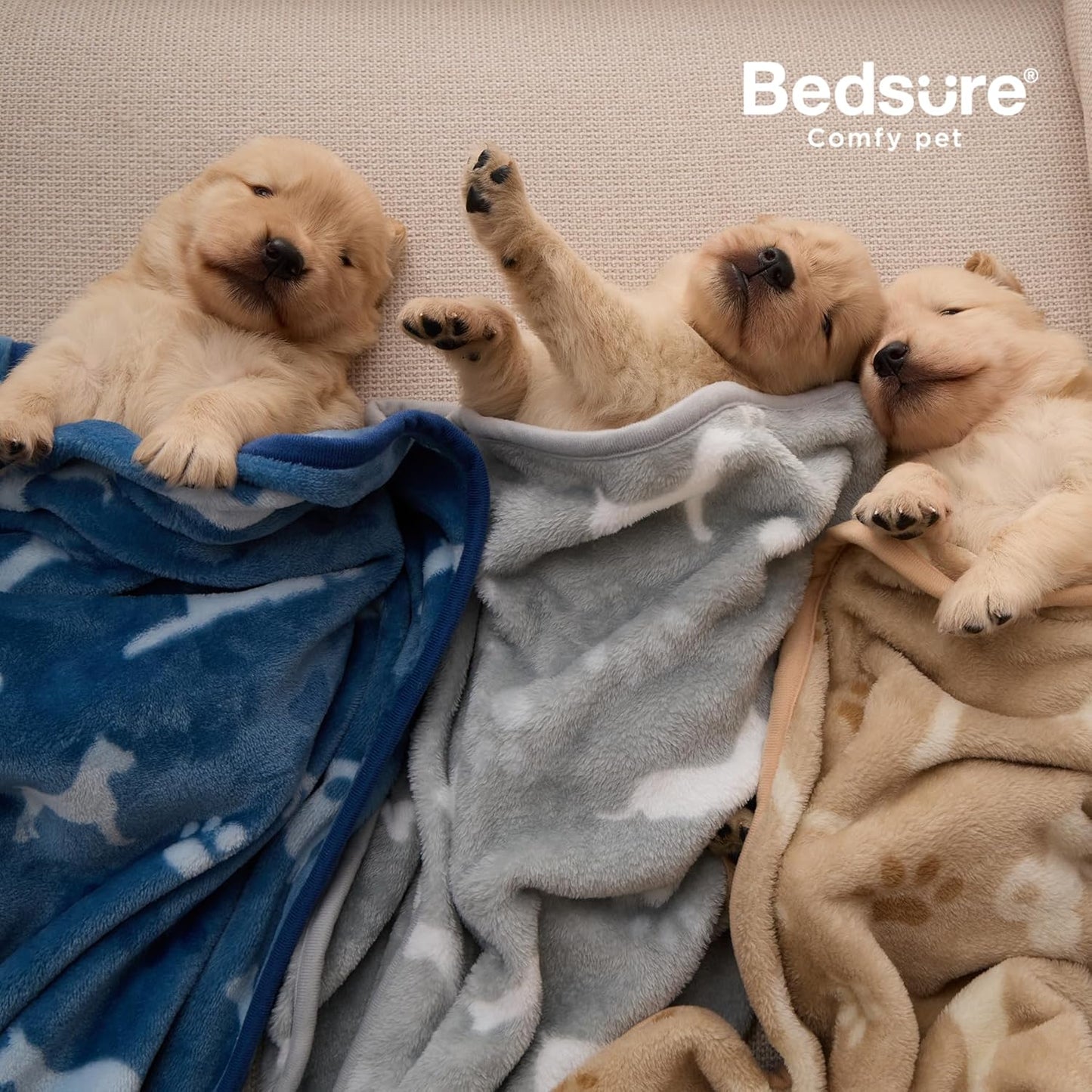 Bedsure ultra soft flannel fleece puppy blankets spread out on a living room couch.