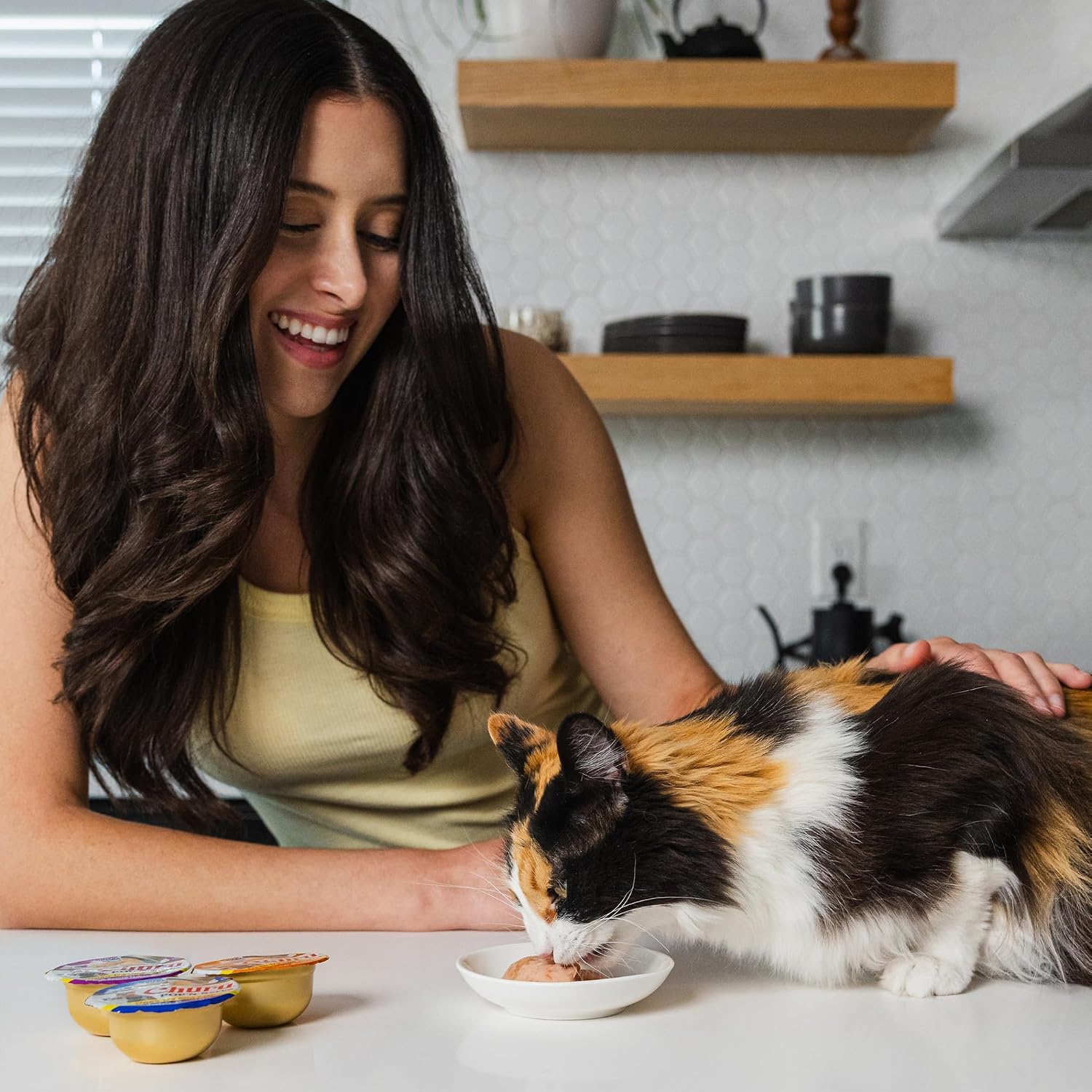 Cat enjoying Inaba Churu jelly treat from a bowl