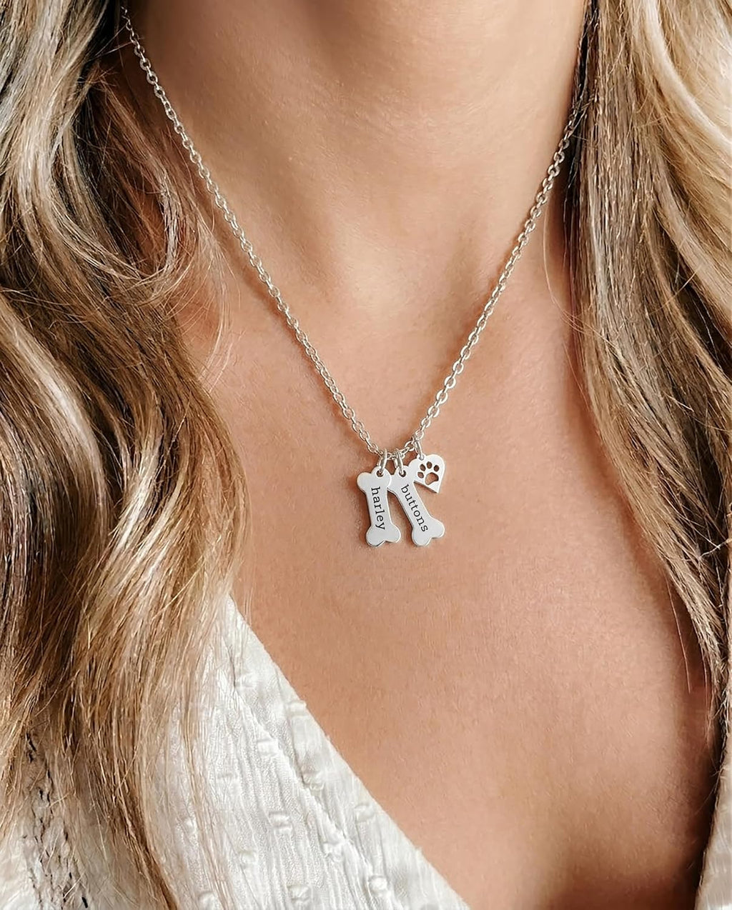 Personalized sterling silver paw print heart charm on an 18 inch chain close up
