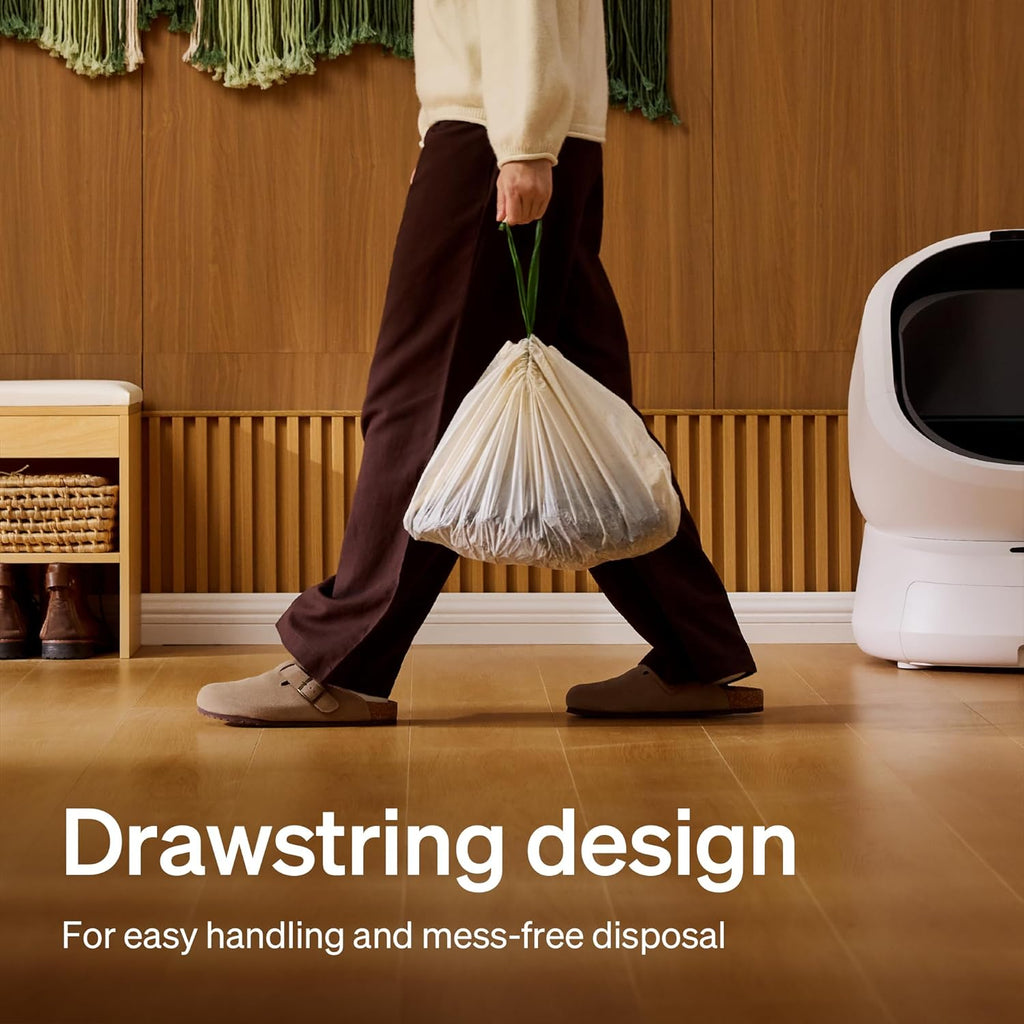 Pet parent lifting the sealed PETLIBRO automatic waste drawer liner using the convenient drawstring.