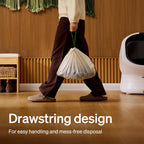 Pet parent lifting the sealed PETLIBRO automatic waste drawer liner using the convenient drawstring.