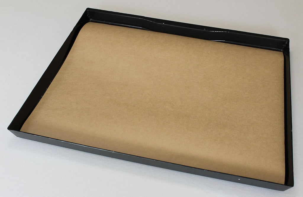 BirdCageLiners kraft paper sheets placed inside a metal bird cage slide-out tray