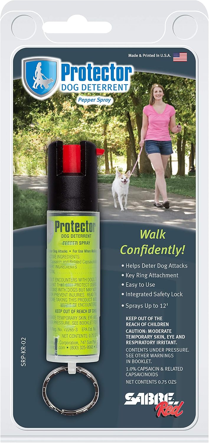 Person holding SABRE dog spray during a walk