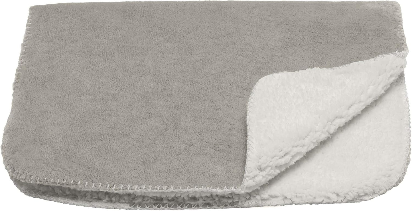 Reversible side of the Furhaven thermal pet blanket on a living room sofa