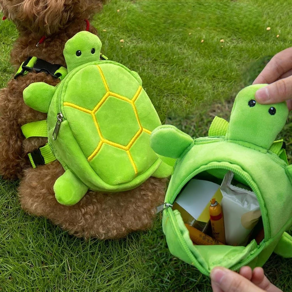Small dog wearing green plush turtle backpack harness for walking
