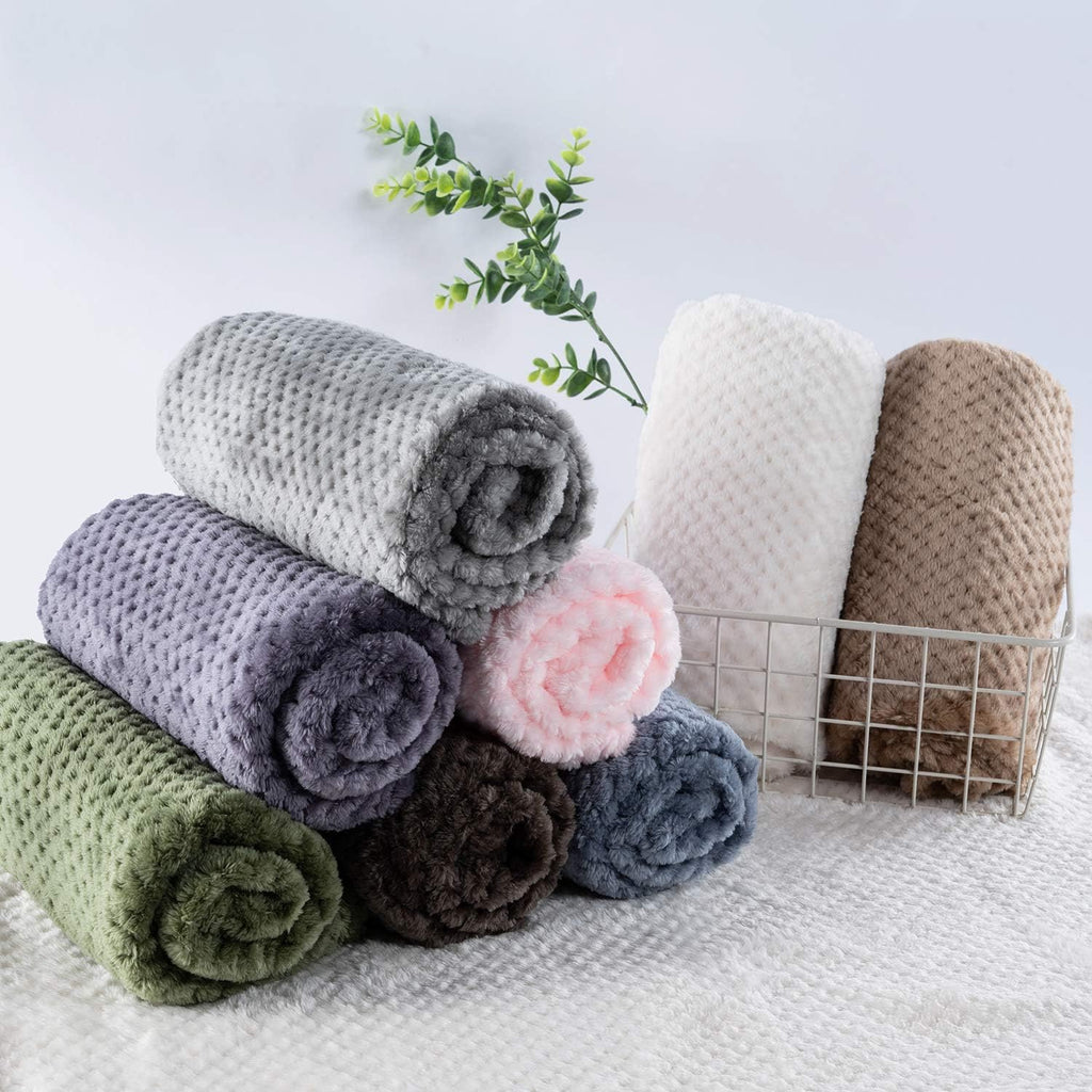 Dark green CUTEMATE plush pet fleece being placed inside a car seat for travel.